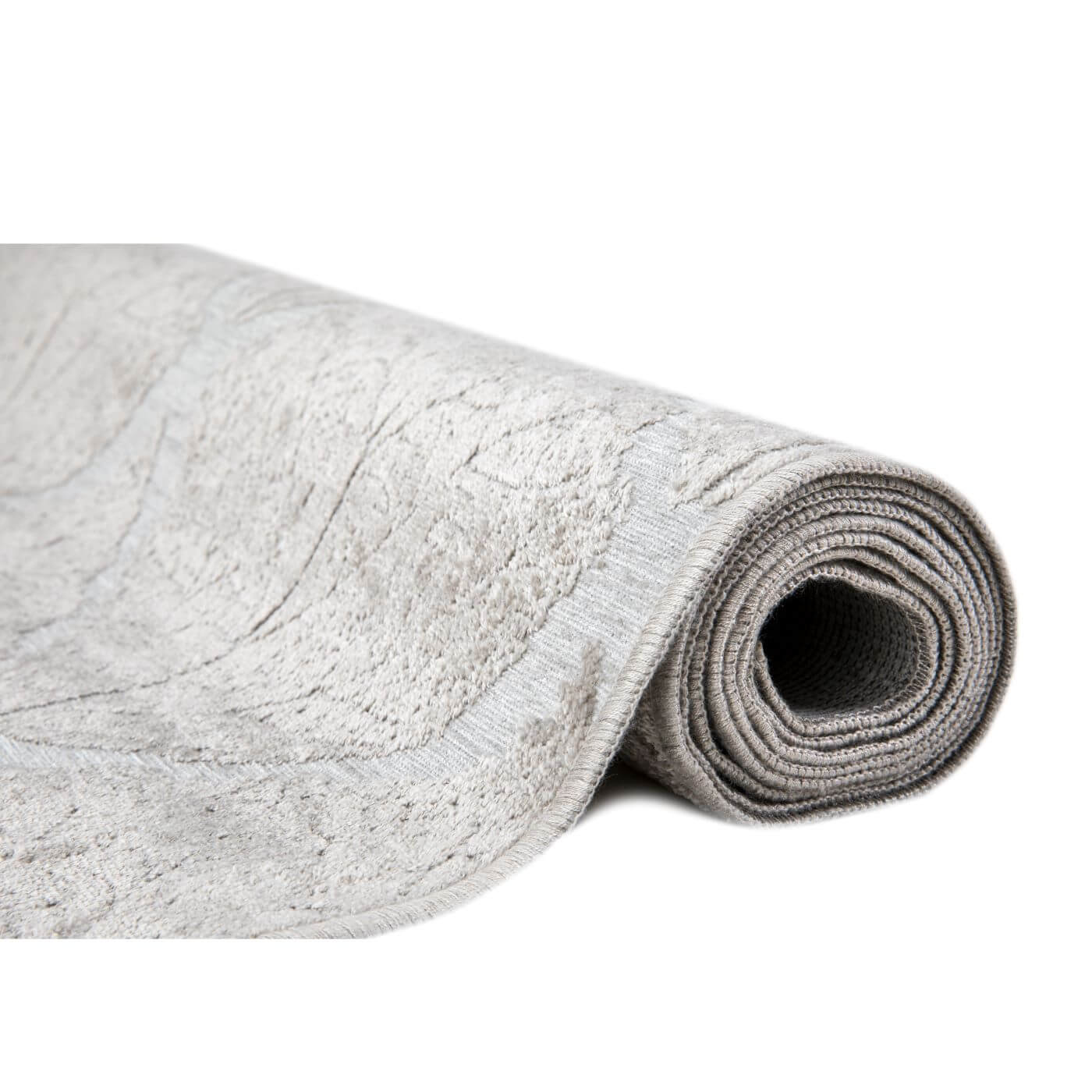 Częściowo zwinięty dywan liście BIRKE. Nowoczesny skandynawski dywan z połyskiem o krótkim włosiu, antyalergiczny
