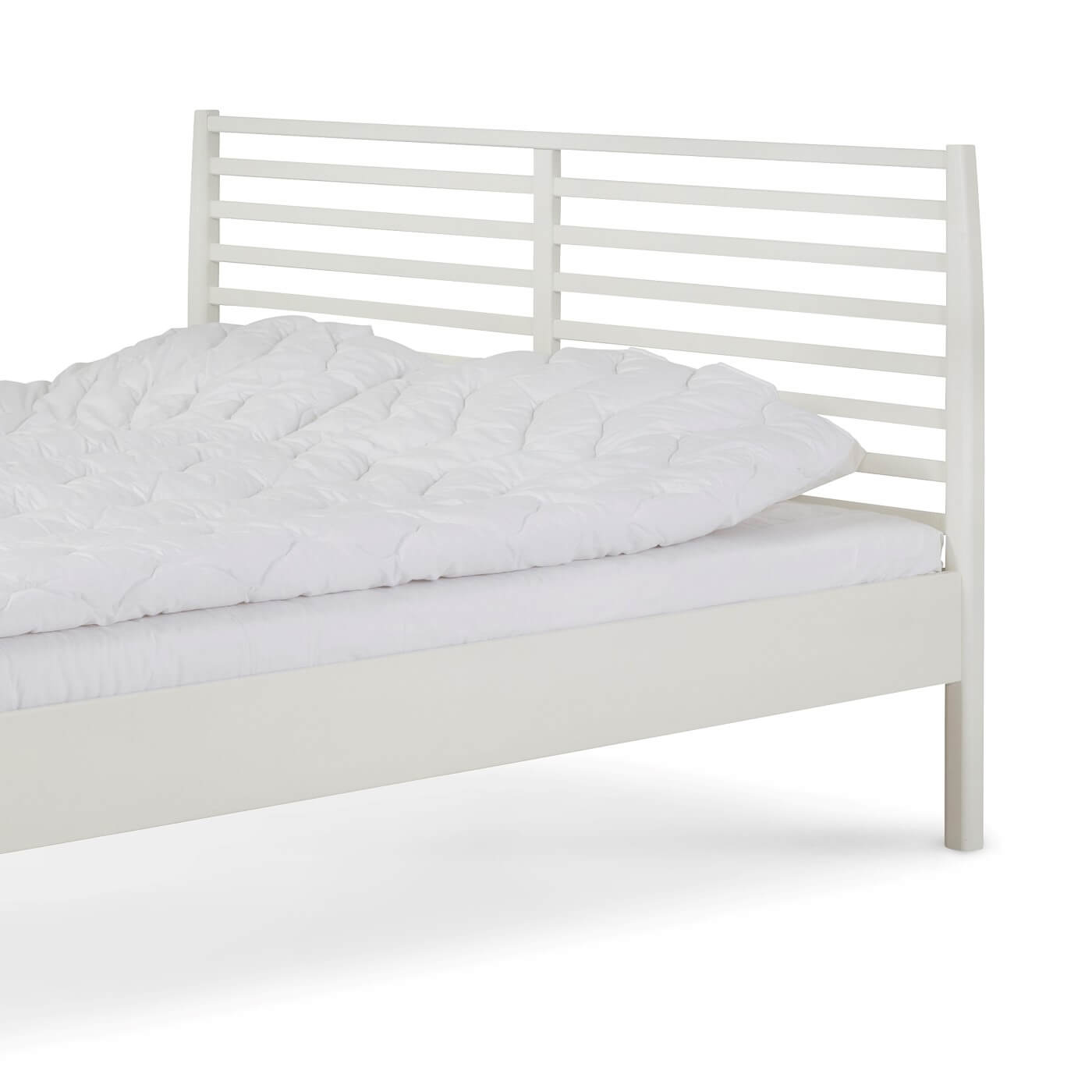 Łóżko drewniane białe 160x200 NOTTE. Fragment białego łóżka z drewna brzozy z wysokim ażurowym zagłówkiem i leżącą białą kołdrą. Nowoczesny skandynawski design